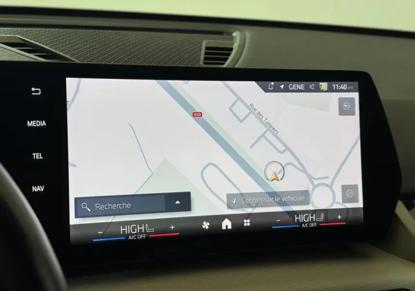 Écran tactile central du tableau de bord du BMW X1 2024 affichant la navigation et les commandes de climatisation.