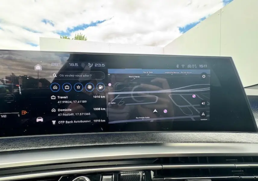 Vue intérieure du tableau de bord numérique du Peugeot 3008 gris titane, affichant la navigation et les options multimédia.