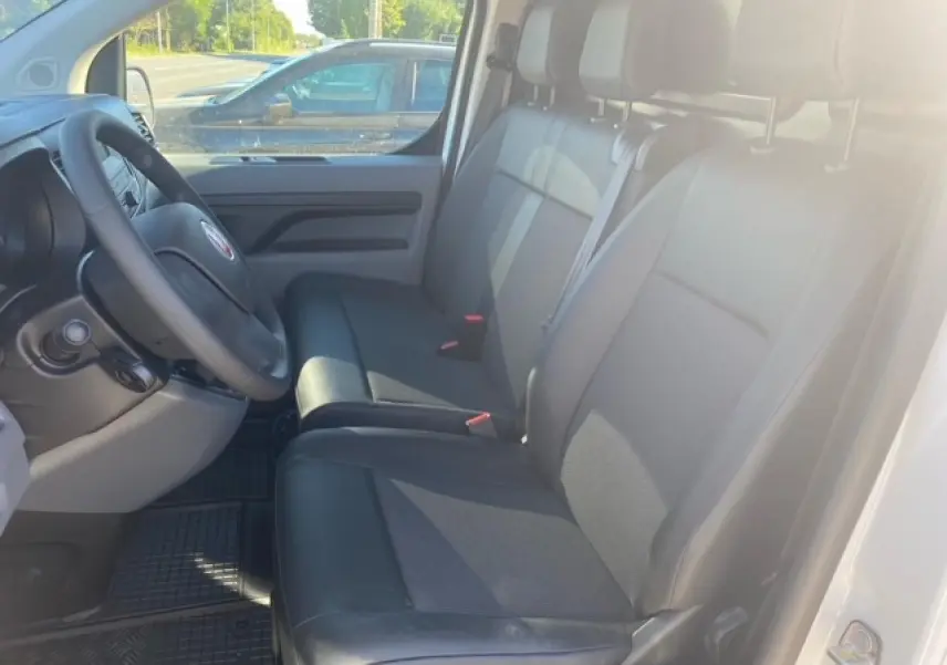 Vue intérieure côté conducteur du Fiat Scudo Fourgon blanc 2022, banquette passager 2 places Moduwork en tissu noir.