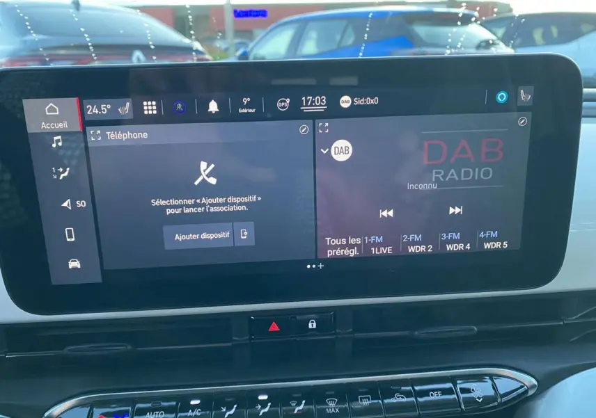 Écran tactile central du tableau de bord de la Fiat 500 électrique blanc, affichant les options téléphone et radio DAB.