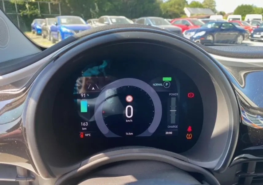 Vue rapprochée du tableau de bord numérique de la Fiat 500 électrique 2022, affichant vitesse et autonomie.