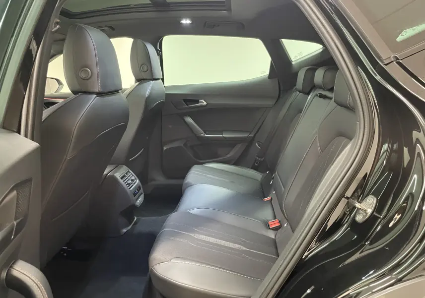 Vue intérieure arrière côté droit du CUPRA Formentor 1.5 TSI 150 DSG7 VZ-LINE 2023 avec sièges cuir noirs et toit panoramique.