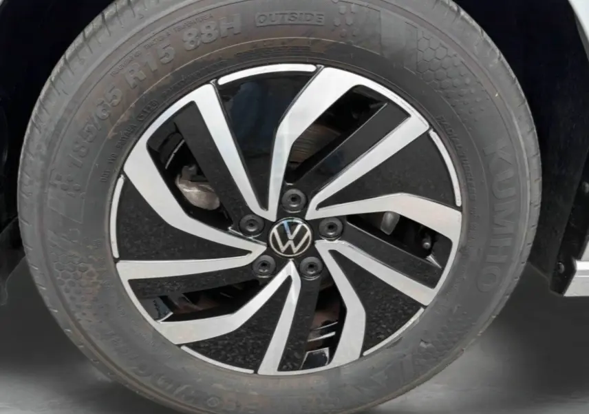 Gros plan sur la jante en alliage noir et argent de la Volkswagen Polo grise, mettant en valeur le logo VW central.