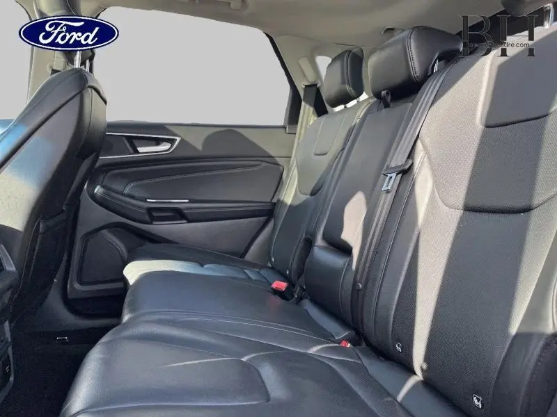 Vue intérieure côté droit des sièges arrière en cuir noir du Ford Edge 2016, avec ceintures et appuie-têtes visibles.