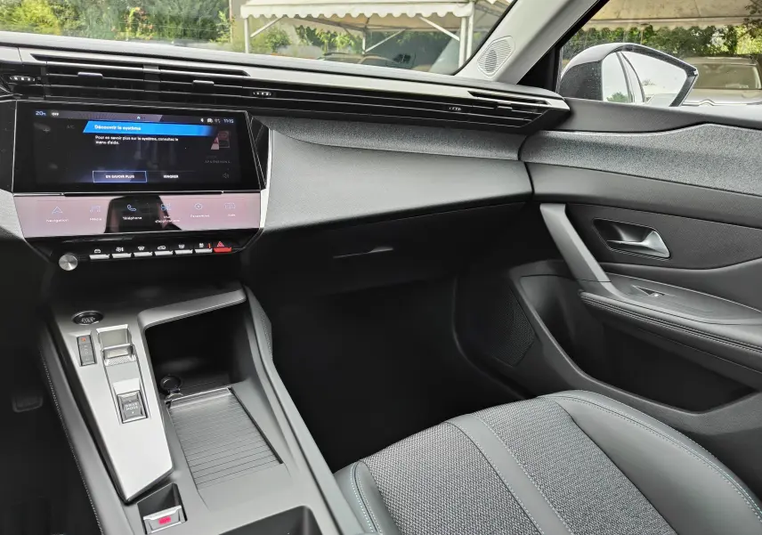 Intérieur de la Peugeot 308 PureTech 130 Allure Pack 2023, vue côté passager, tableau de bord moderne avec écran tactile.