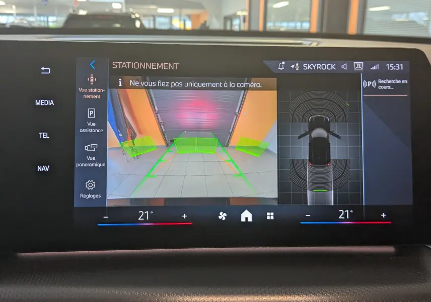 Affichage de la caméra de recul et vue 360° du BMW X1 noir, avec aides au stationnement sur l'écran central.