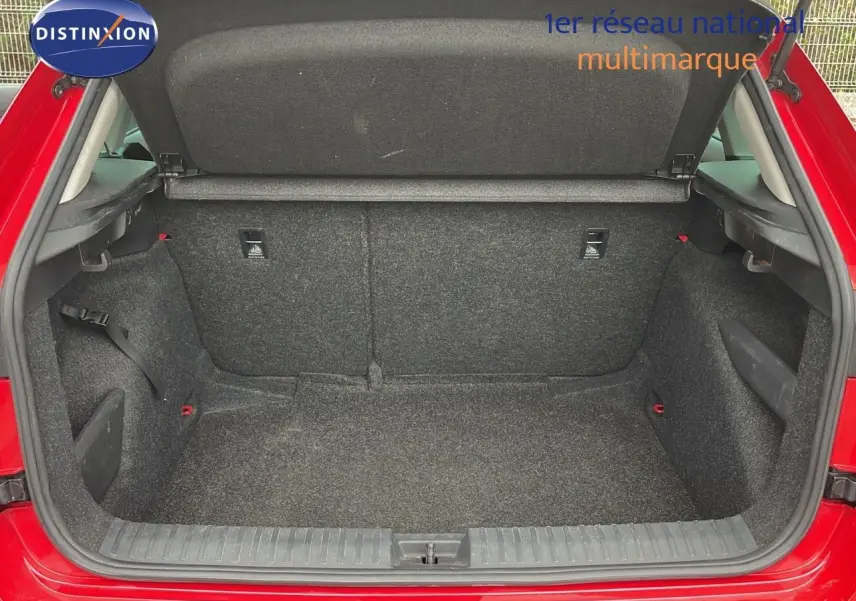 Coffre ouvert d'un Skoda Kamiq rouge Velvet Metal, montrant un espace de chargement propre et spacieux.