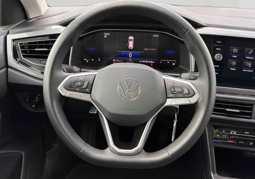 Vue rapprochée du volant cuir noir et du tableau de bord digital de la Volkswagen Polo 2025 avec écran tactile central.