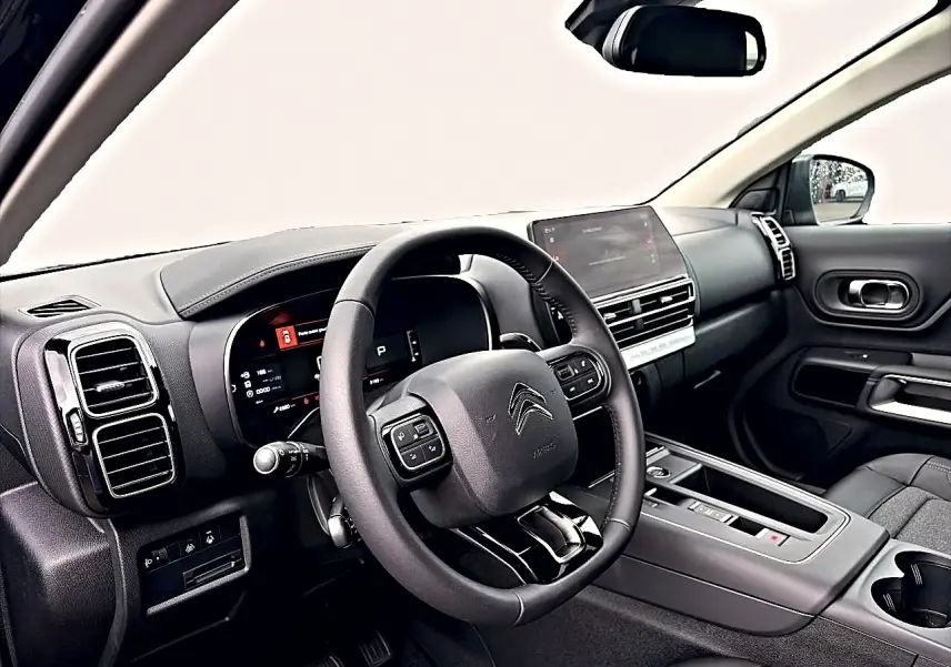 Intérieur noir du Citroën C5 Aircross 2025 vu côté conducteur, avec tableau de bord digital et écran tactile central.