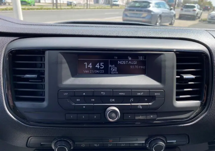 Tableau de bord du Peugeot Expert Fourgon blanc 2023, vue frontale centrée sur l'autoradio et les commandes climatiques.