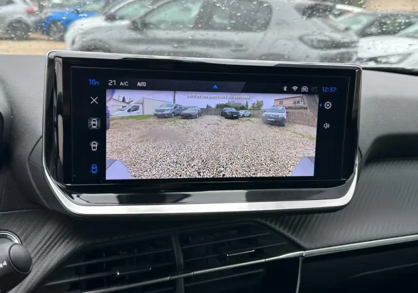 Écran tactile intérieur du Peugeot 2008 Hybrid 136 Allure montrant la caméra de recul avec vue arrière sur gravier.