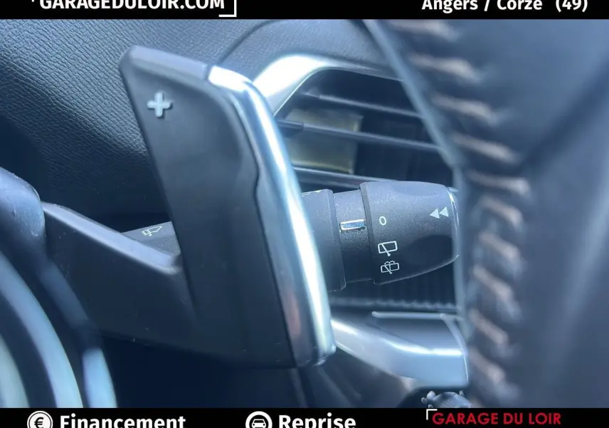 Gros plan sur la palette de changement de vitesse + au volant du Peugeot 3008 Bleu Celebes, intérieur noir Mistral.