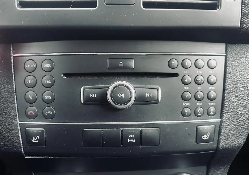 Console centrale noire du Mercedes GLK 220 CDI 4-Matic 2010 avec commandes radio, téléphone et sièges chauffants.