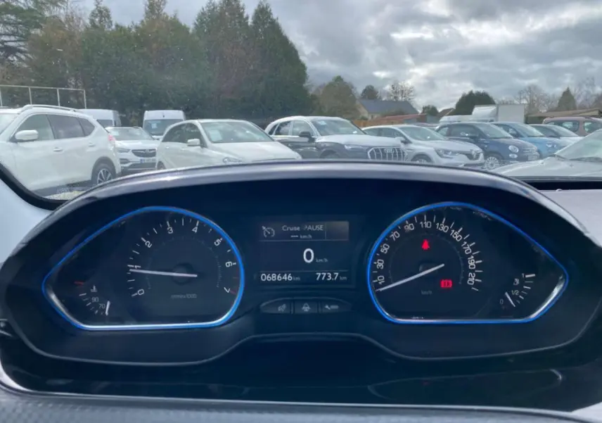 Vue du tableau de bord de la Peugeot 2008 gris platinium, affichant le compteur et l'ordinateur de bord à l'arrêt.