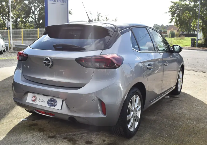 Vue 3/4 arrière droite d'une Opel Corsa gris métallisé 2021 avec feux arrière foncés et jantes alliage.