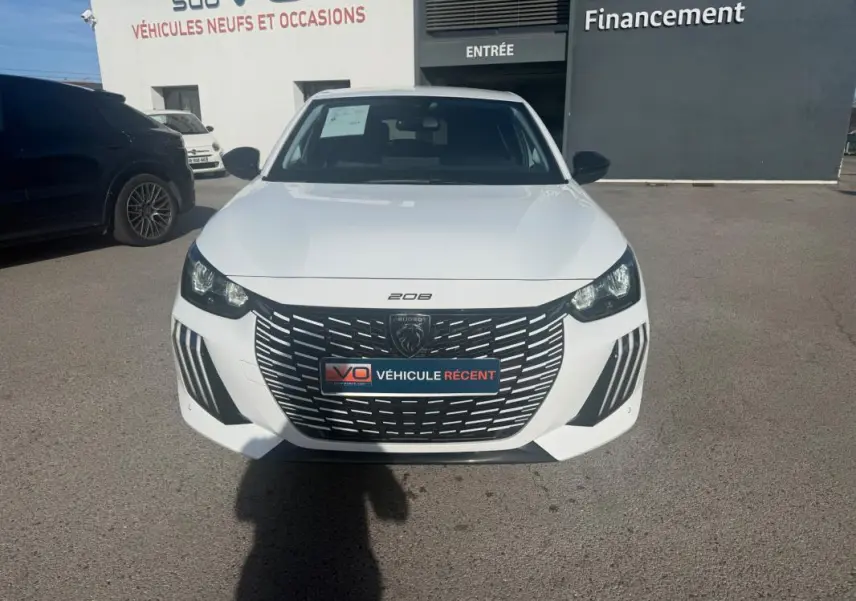 Peugeot 208 Hybrid blanc vue de face, mettant en valeur la calandre noire distinctive et les phares LED.