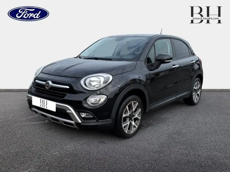 Vue 3/4 avant droite d'une Fiat 500X noire Cinéma pastel avec jantes alu et barres de toit visibles.