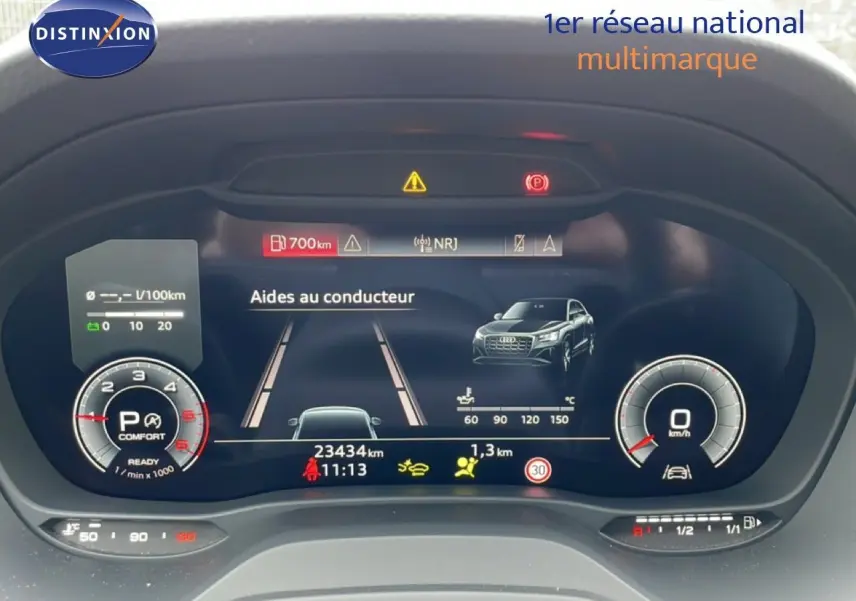 Tableau de bord numérique d'Audi Q2 noir mito, affichant les aides au conducteur et compteurs en vue frontale.