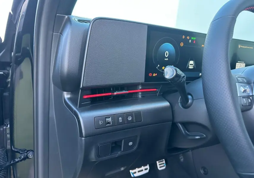 Vue intérieure frontale du tableau de bord noir du Hyundai Kona 2026 avec écran tactile large et volant cuir.