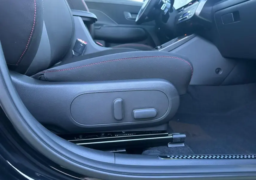 Vue intérieure côté gauche du siège avant noir avec surpiqûres rouges du Hyundai Kona II 1.6 Hybrid N Line 2026.
