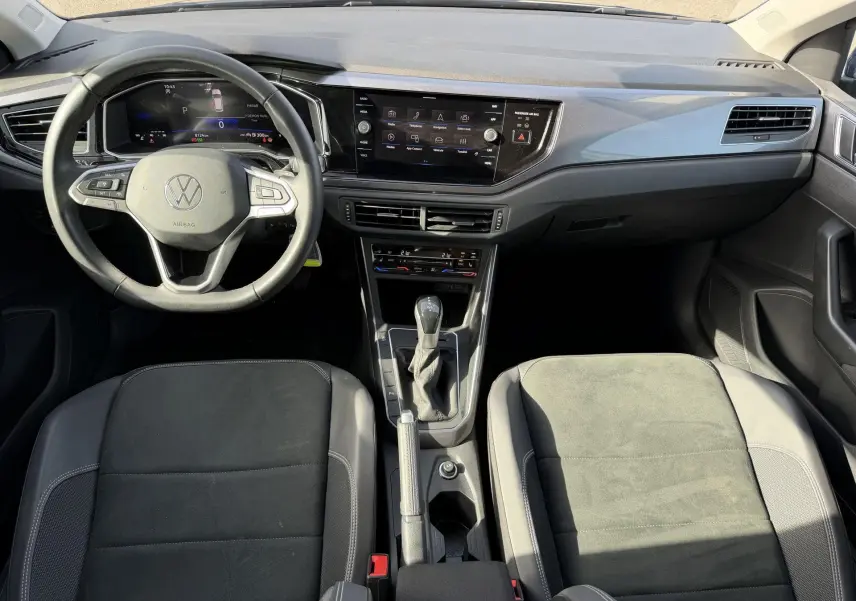 Vue intérieure avant de la Volkswagen Polo 2025, tableau de bord moderne avec écran tactile et volant multifonctions cuir.