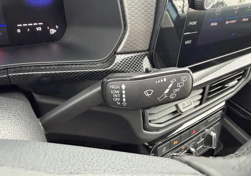 Gros plan sur la commande des essuie-glaces côté gauche du tableau de bord du Volkswagen T-Cross 2025, intérieur noir.