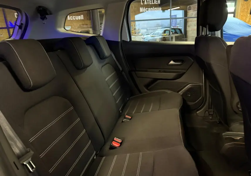 Vue intérieure côté droit des sièges arrière noirs avec surpiqûres blanches du Dacia Duster gris 2019 Prestige.