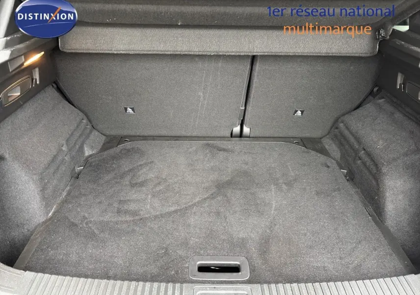 Coffre spacieux et propre du Renault Austral noir étoile métal, vue intérieure arrière avec tapis de sol gris foncé.