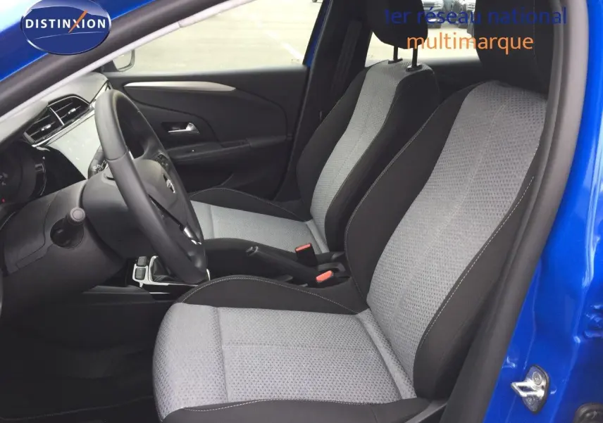 Vue intérieure côté conducteur de l'Opel Corsa bleu voltaik métal 2025, sièges tissu noir et gris clair.