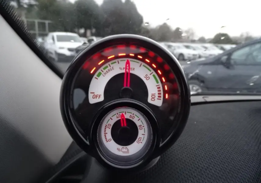 Gros plan sur l'indicateur de puissance et batterie du tableau de bord d'une Smart Forfour électrique blanche.