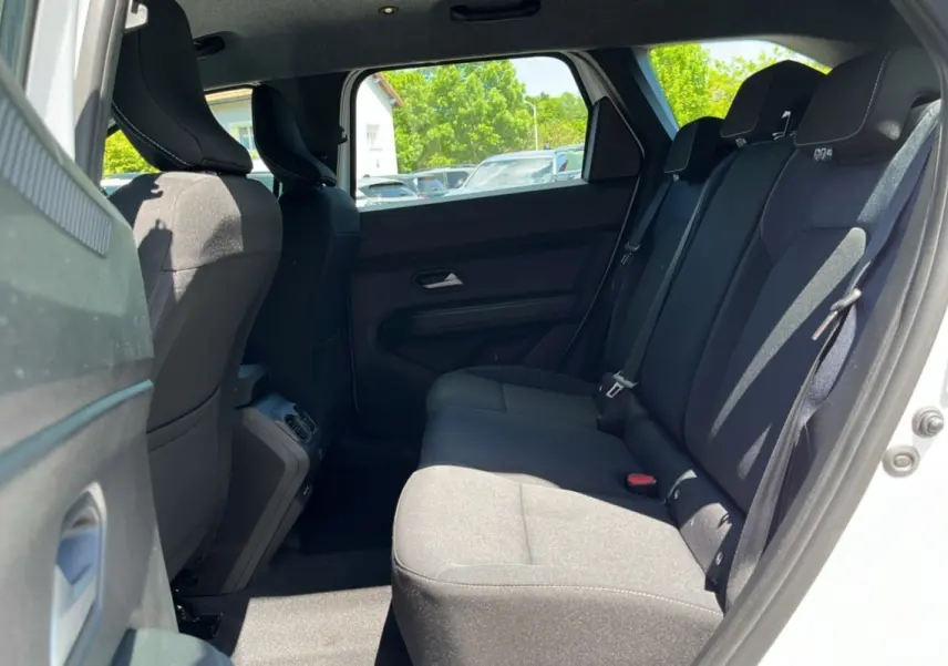 Vue intérieure côté droit sur la banquette arrière noire du Dacia Bigster blanc glacier 2025, avec appuie-têtes et ceintures visibles.