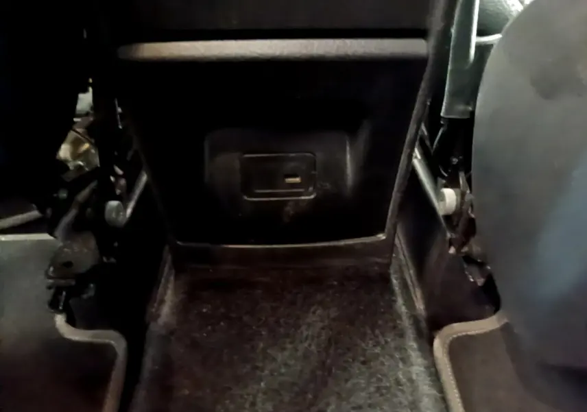 Détail du plancher arrière noir du Mercedes GLB 200 d Business Line 2021, avec prise électrique sous le siège.