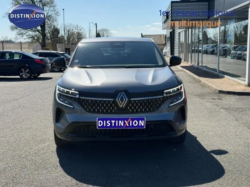 Vue de face du Renault Austral gris schiste 2024 avec calandre noire et feux LED distinctifs allumés.