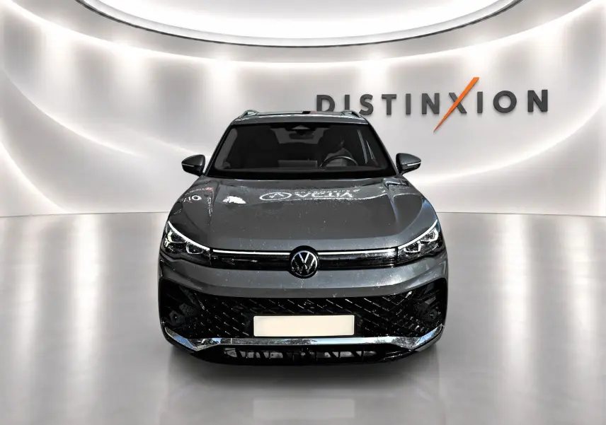 Volkswagen Tiguan 2.0 TDI gris dauphin, vue avant centrée, avec calandre noire et logo VW visible.