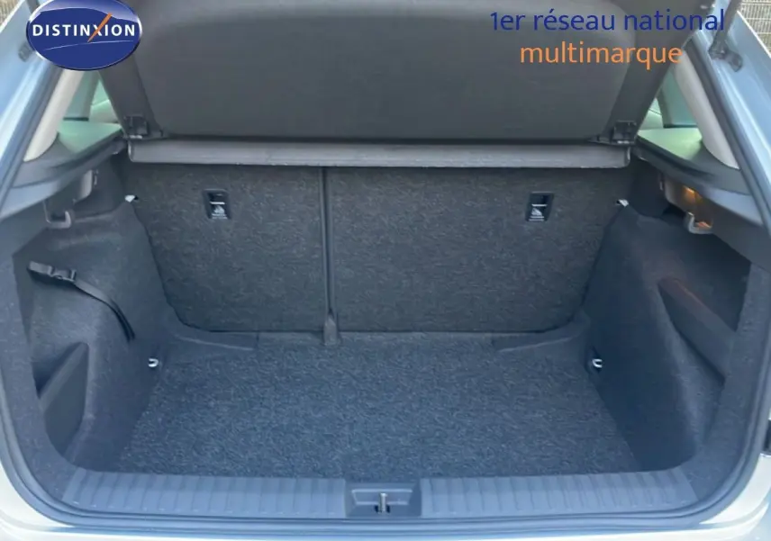 Coffre ouvert vu de l'arrière d'un Skoda Kamiq gris argent métal 2025, espace de chargement vide et propre.