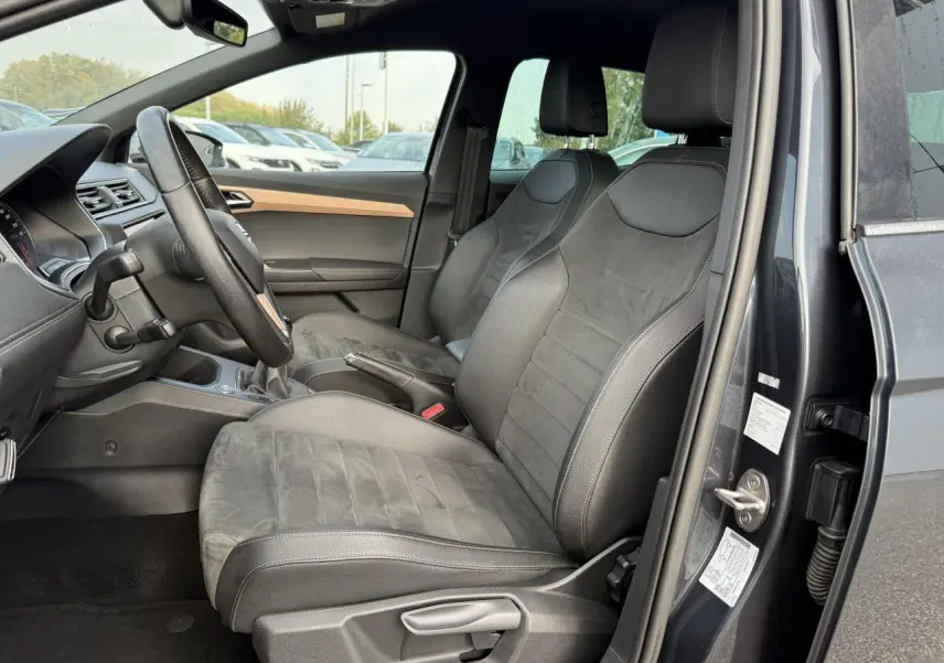 Intérieur côté conducteur de la SEAT IBIZA 2019 gris Magnetic Tech, sièges confort en tissu et alcantara, volant et tableau de bord visibles.