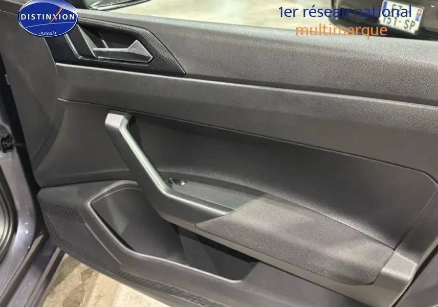 Vue intérieure côté gauche de la porte avant gris cendre de la Volkswagen Polo 2025 avec accoudoir et haut-parleur intégré.