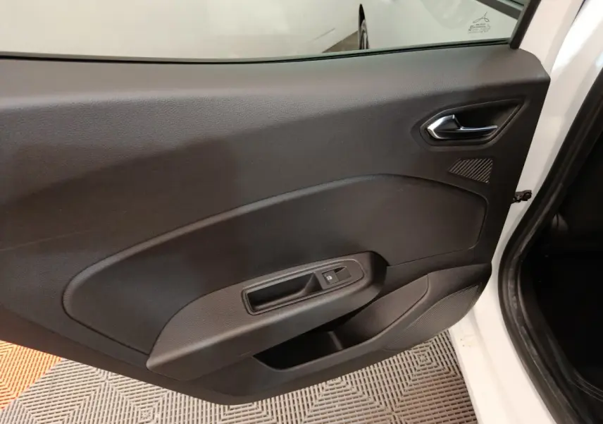 Vue intérieure de la porte arrière droite noire d'une Renault Clio Evolution TCe 90 blanche 2023, avec commande de vitre.