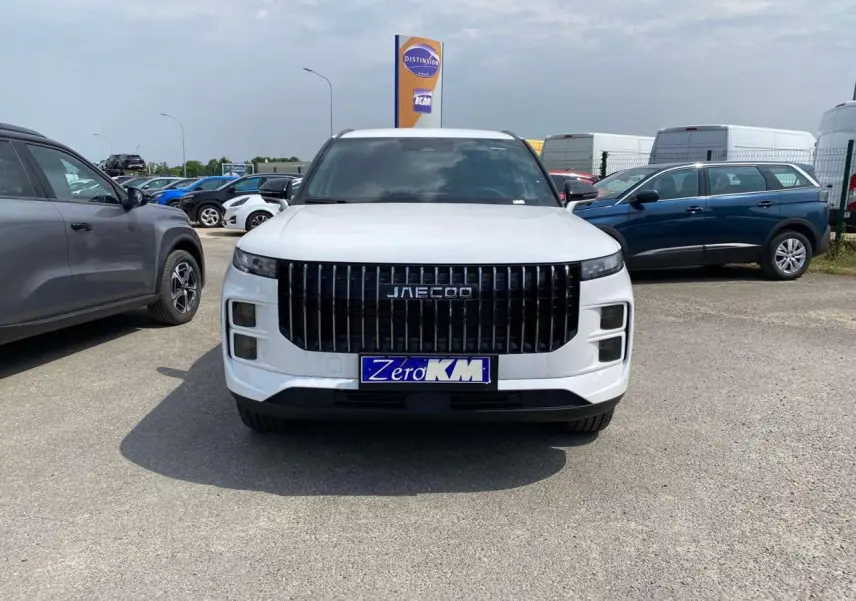 Vue frontale du SUV JAECOO J7 blanc khaki 2026 avec calandre verticale noire et plaque d’immatriculation Zero KM.