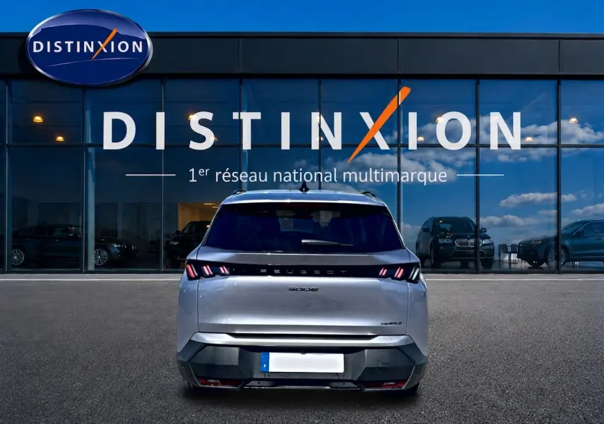 Vue arrière d’un Peugeot 5008 Hybrid 145 allure e-dcs6 gris artense, avec feux arrière LED et logo distinctif.