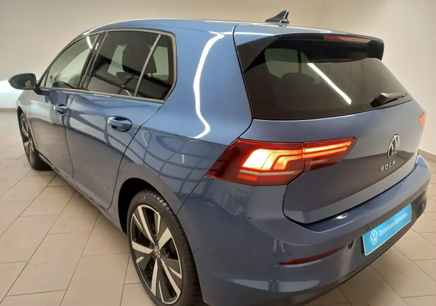 Vue 3/4 arrière gauche d'une Volkswagen Golf 1.5 TSI 116 BVM6 en bleu Anemone avec jantes alliage 18 pouces Catania.
