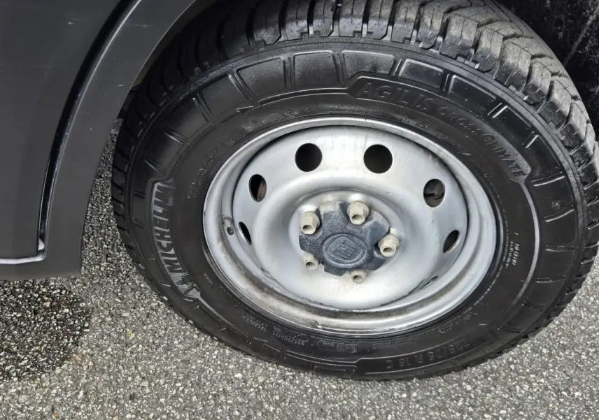 Gros plan sur la roue avant gauche du Fiat Ducato Fourgon blanc, pneu Michelin Agilis CrossClimate visible.