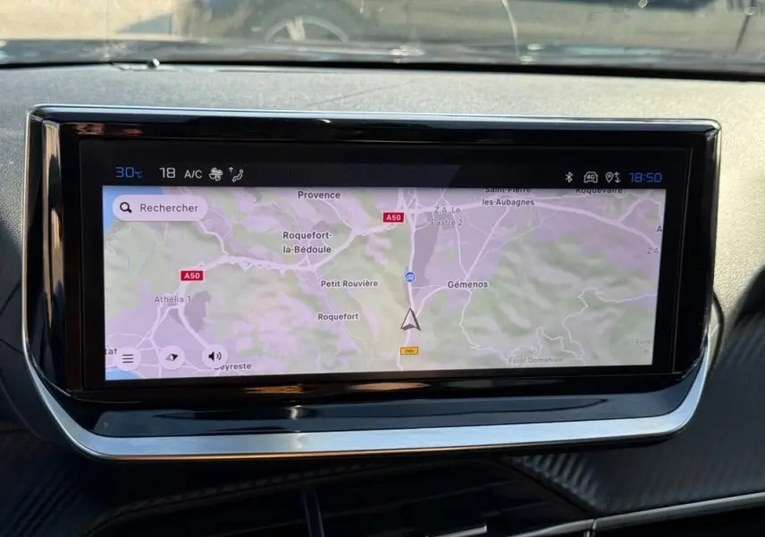 Écran tactile du tableau de bord du Peugeot 2008 Hybrid 136 Allure, affichant une carte de navigation.