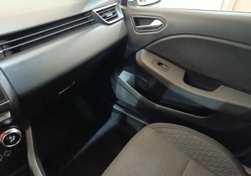 Intérieur côté passager de la Renault Clio Business E-TECH 140 2021, montrant la porte et la partie basse du tableau de bord.