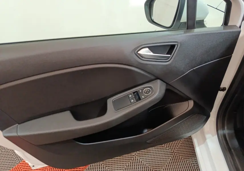 Vue intérieure de la porte avant gauche de la Renault Clio Business E-TECH 140 blanche, avec commandes de vitres et rétroviseur.
