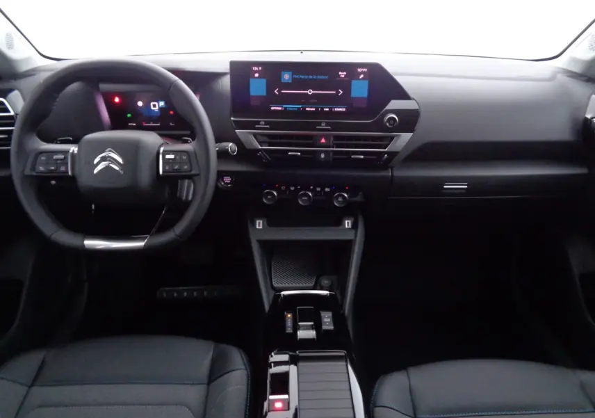 Vue intérieure du tableau de bord et volant noir du Citroën C4 2023 avec écran tactile central et console moderne.