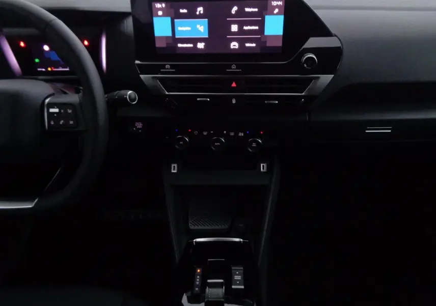 Vue rapprochée du tableau de bord et console centrale noire de la Citroën C4 2023 avec écran tactile et boîte automatique.