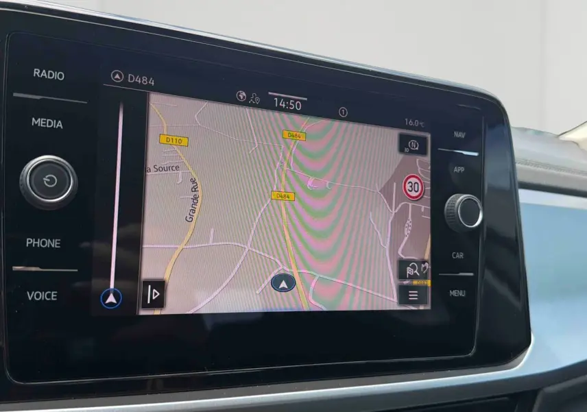 Écran tactile central du Volkswagen T-Roc 2025 affichant la navigation avec carte et signalisation routière.