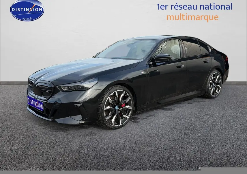 BMW Série 5 i5 M60 noir vue 3/4 avant droit avec jantes alu bicolores et calandre noire distinctive.