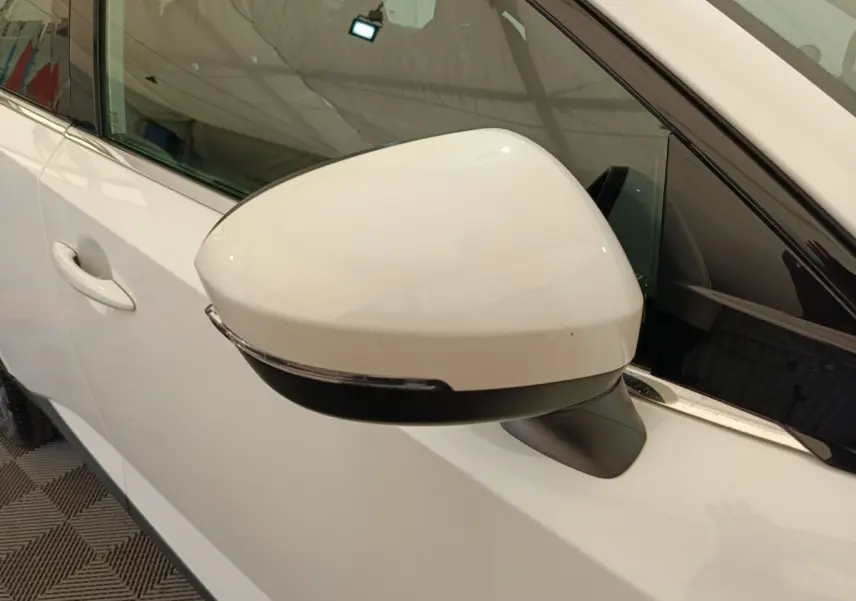 Rétroviseur droit blanc du Nissan Qashqai e-Power 2024 avec clignotant intégré, vue rapprochée côté conducteur.